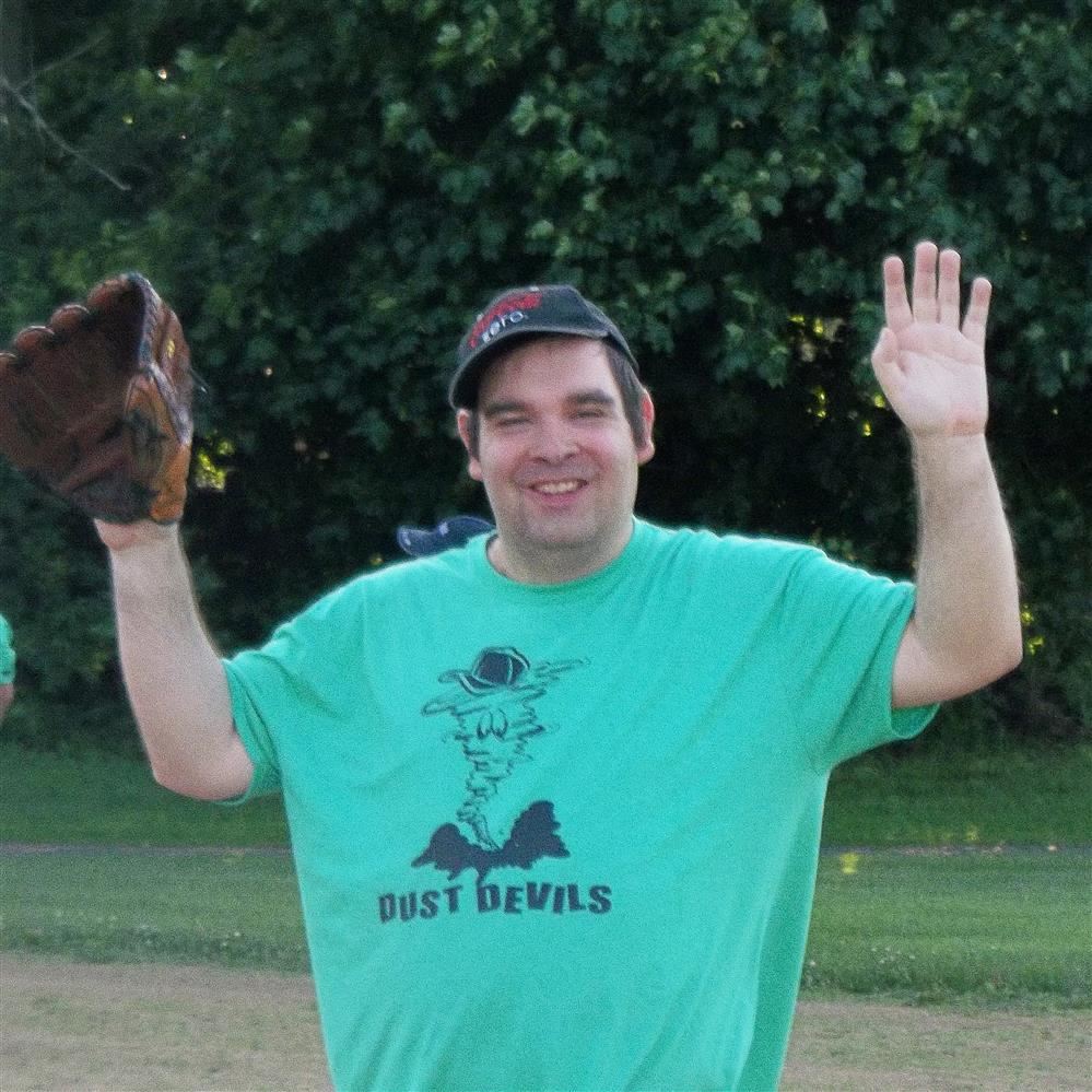  Adult with special needs attends softball activities outdoors